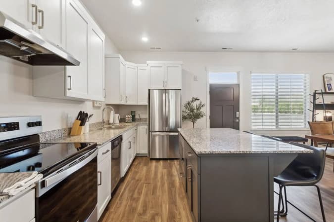 Granary kitchen with a granite island and stainless appliances